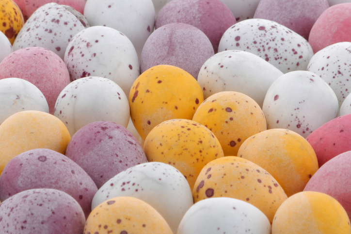 Photo showing a bunch of different coloured Easter Eggs.