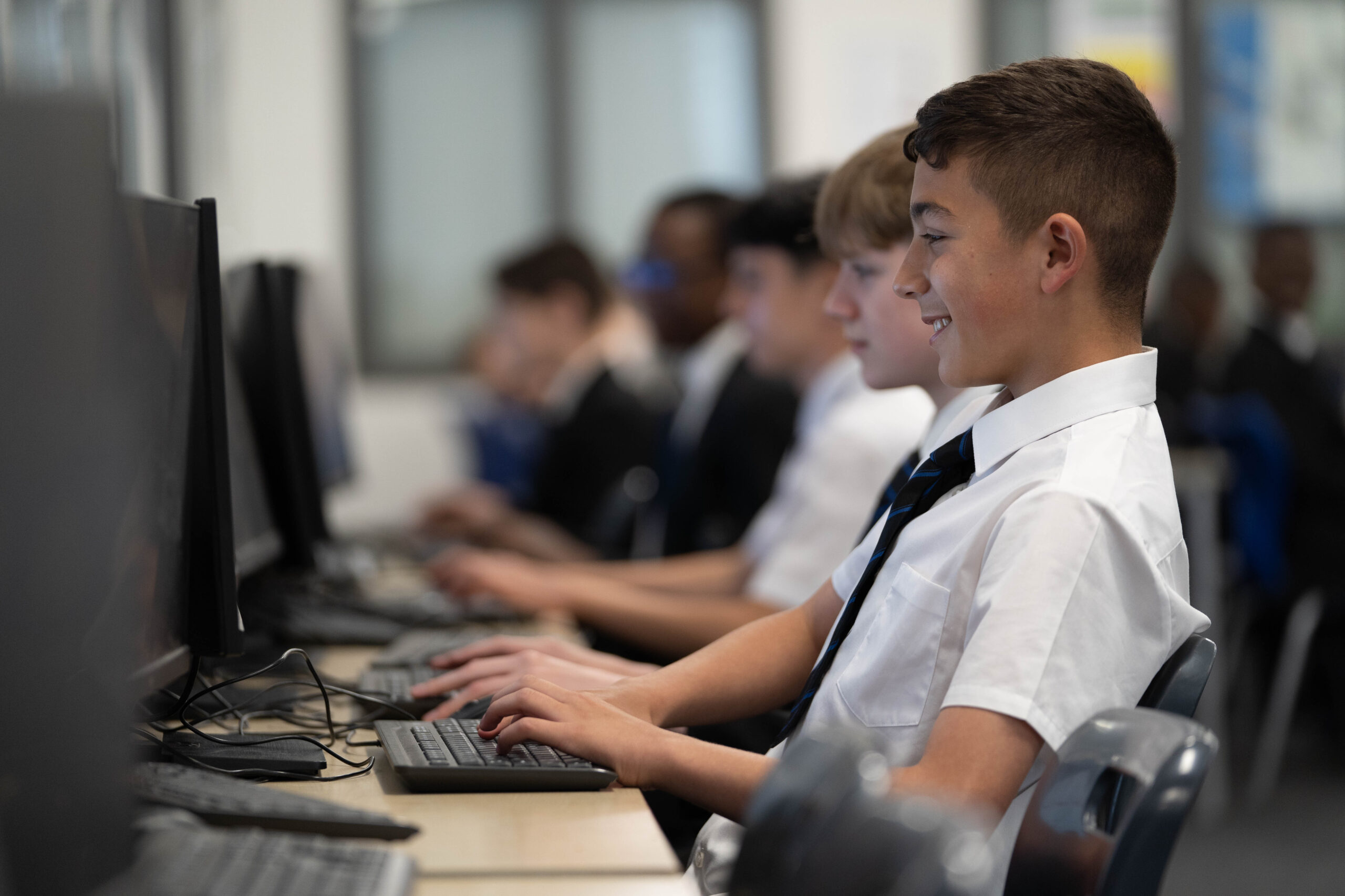 A row of students on computers